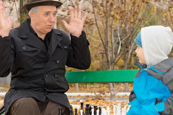 Cute little boy confronting his grandfather — Stock Photo, Image