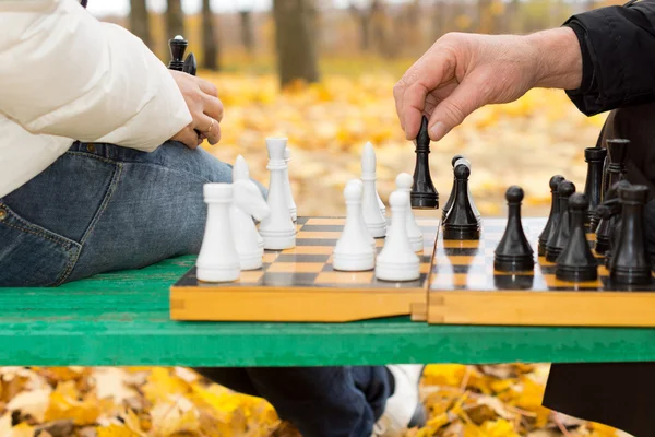 Elderly man making a chess move — Stock Photo, Image