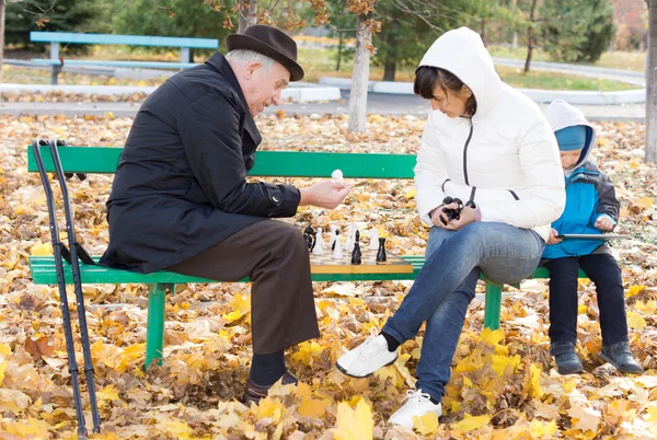 Atractiva mujer jugando ajedrez con su padre — Foto de Stock