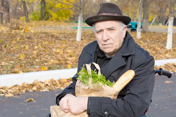 彼は食料品と車椅子の年配の男性人 — ストック写真