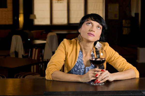 Thoughtful woman sitting at the bar — Stock Photo, Image