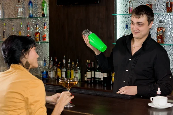 Friendly barman chatting to a female customer — Stock Photo, Image