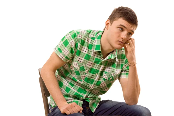 Watchful young man sitting thinking — Stock Photo, Image