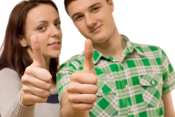 Attractive young couple giving a thumbs up — Stock Photo, Image