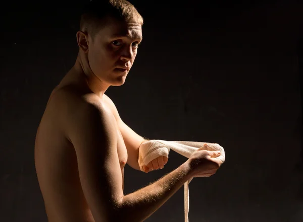 Jovem pugilista se preparando na escuridão — Fotografia de Stock