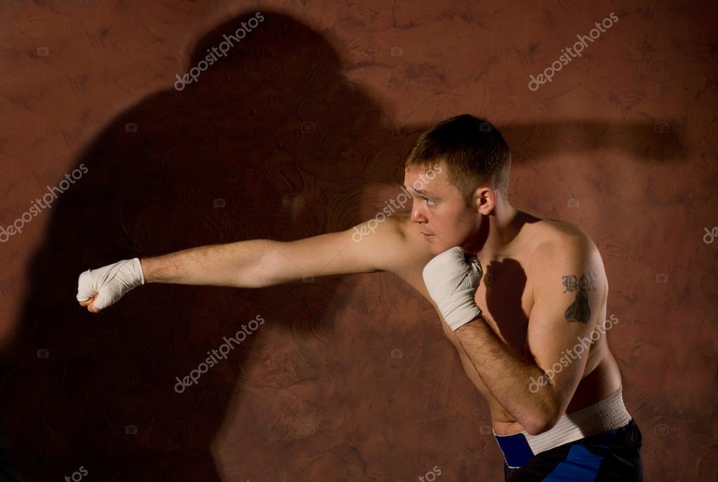 Young boxer punching an opponent — Stock Photo © Vaicheslav #42021265