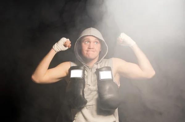 Determined young boxer raising his fists — Stock Photo, Image