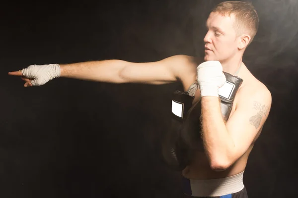 Muskulös unga boxare pekar hans hand — Stockfoto