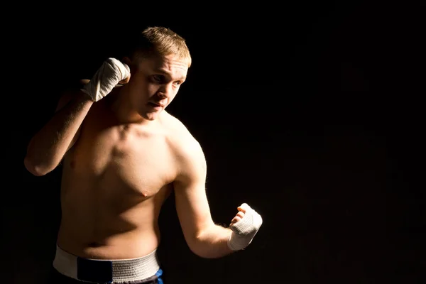 Strong fit young boxer fighting in a match — Stock Photo, Image