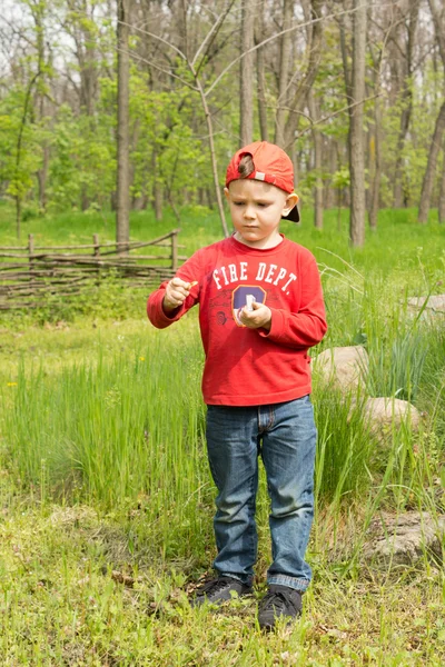 Cute young boy trying to light a match — Stock Photo, Image