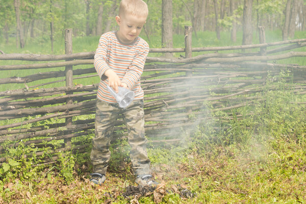 Little boy trying to extinguish a fire