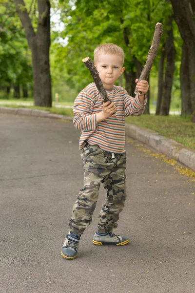 Determined macho little boy stick fighting — Stock Photo, Image