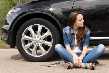Young woman waiting for roadside assistance clipart