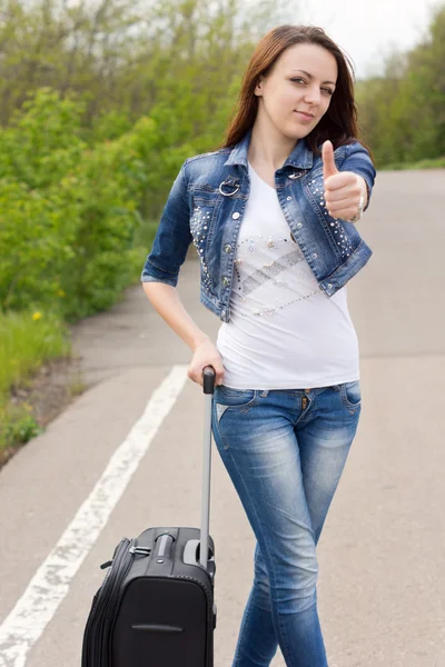Smiling attractive young woman giving a thumbs up — Stock Photo, Image