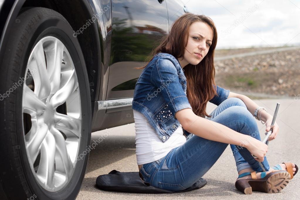 Female driver waiting for roadside assistance