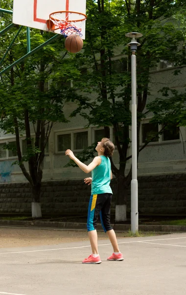 Jonge atletische tienermeisje spelen basketbal — Stockfoto