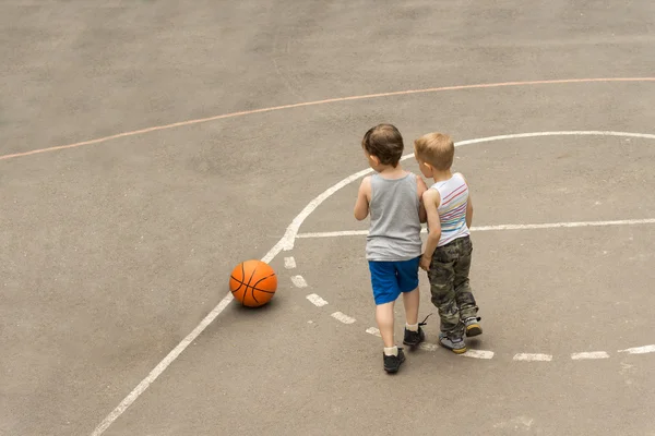 Twee jonge jongens op een basketbalveld — Stockfoto