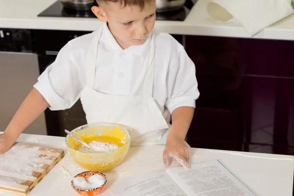 Young boy cook checking ingredients — Stock Photo, Image