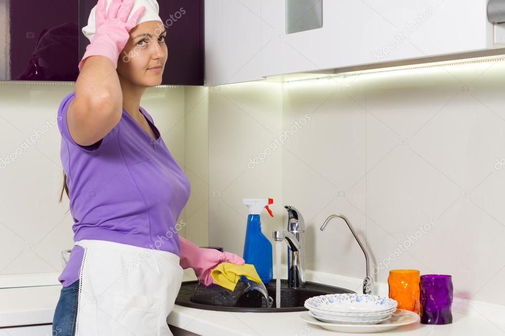 Housewife straightening her cap as she works
