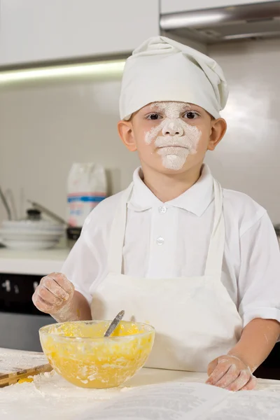 Messy young boy preparing to bake — Stock Photo, Image