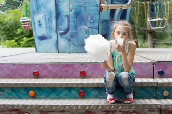 Young girl eating a stick of candy floss — Stock Photo, Image