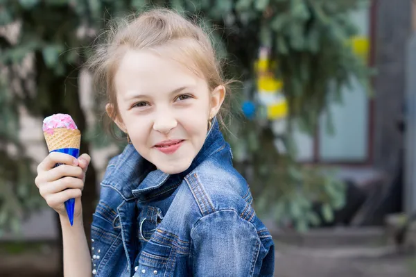 Mischievous young girl enjoying an ice cream cone — Stock Photo, Image