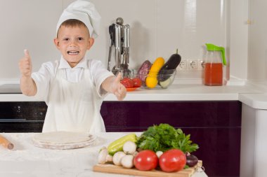 küçük çocuk bir başparmak yapıyor pizza pişirme heyecanlı
