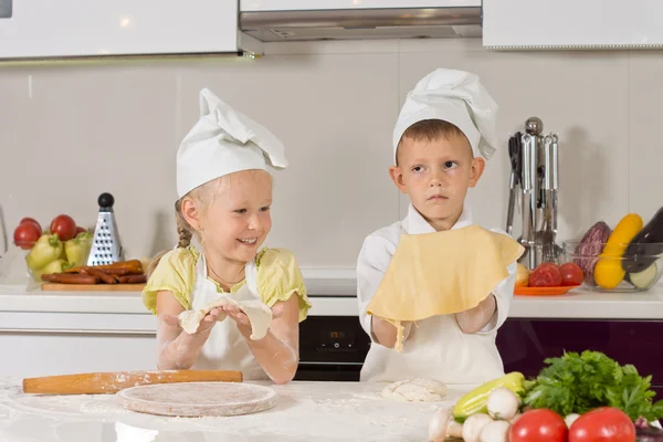 Zwei süße Kinder zeigen Teig, den sie gemacht haben — Stockfoto