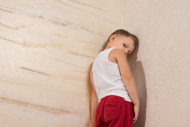 Shy Cute Little Boy on Wooden Walls clipart