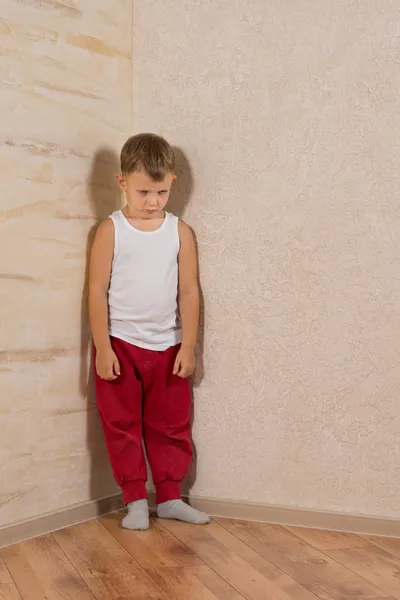 Cute Little Mad Kid on Light Brown Wooden Walls — Stock Photo, Image