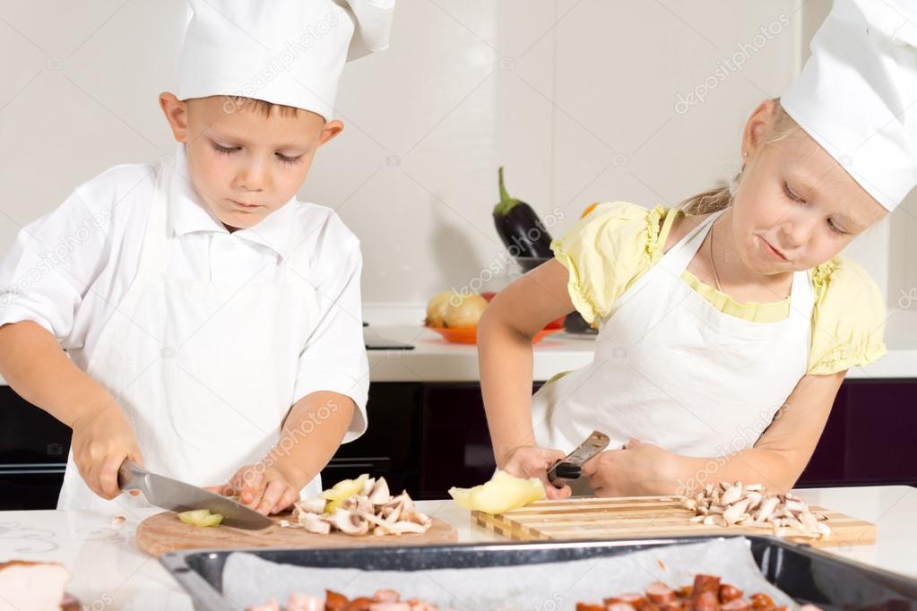 Kid Chefs Slicing Ingredients on Chopping Board