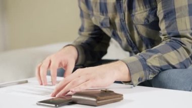 Ödeme yapmadan önce form veya evrak dolduran adam