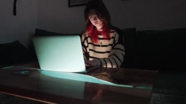 Young woman using the laptop for searching secret information
