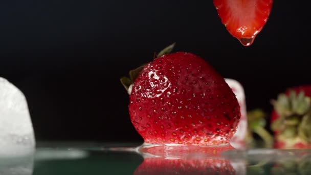 Fresh Red Strawberry Melting Ice Cubes Black Low Angle Side — Stock video