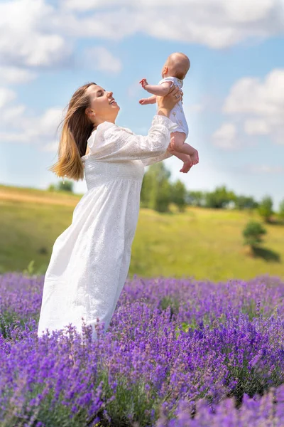 Joyful Young Mother Playing Her Baby Son Twirling Him High — Stock Photo, Image