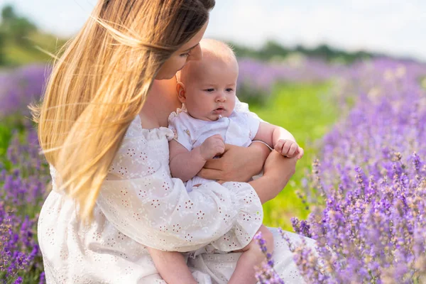 Cute Little Baby Clasped Arms Its Loving Mother Outdoors Field — Zdjęcie stockowe