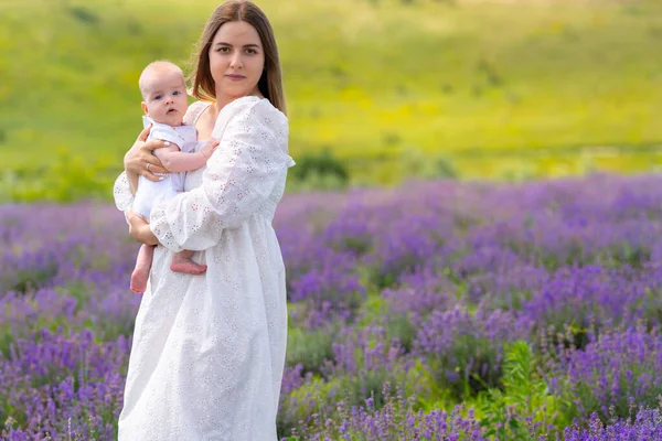 Young Mother Standing Lavender Field Holding Little Baby Her Arms — Stockfoto