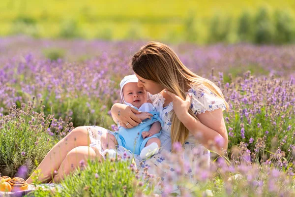 Loving Young Mother Kissing Her Small Baby Son She Relaxes — Fotografia de Stock