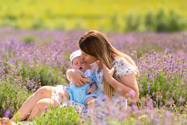 Loving Young Mother Kissing Her Young Baby Boy Relax Outdoors — Fotografia de Stock