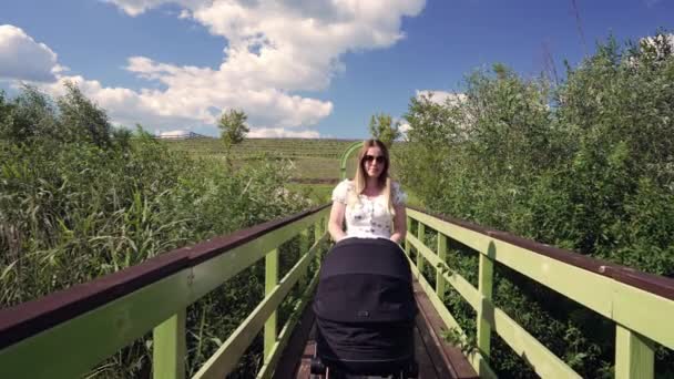 Woman Pushing Her Baby Pram Narrow Foot Bridge Converging Perspective — Stockvideo