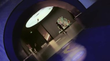 Tilted angle view of an underwater glass tunnel in an aquarium showing the fish swimming outside the domed ceiling