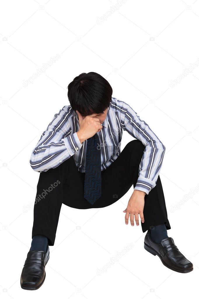 Portrait of sad businessman sitting on the floor