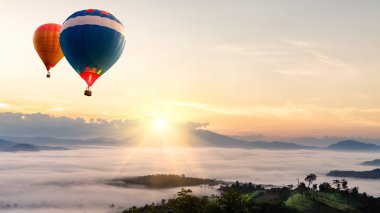 Hot air balloon over sea of mist clipart