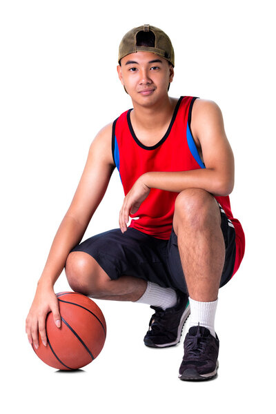 Teenager boy sitting with basketball
