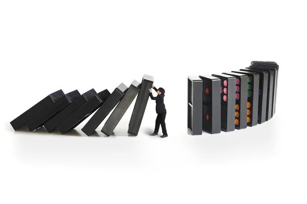 Businessman stopping the domino effect — Stock Photo, Image