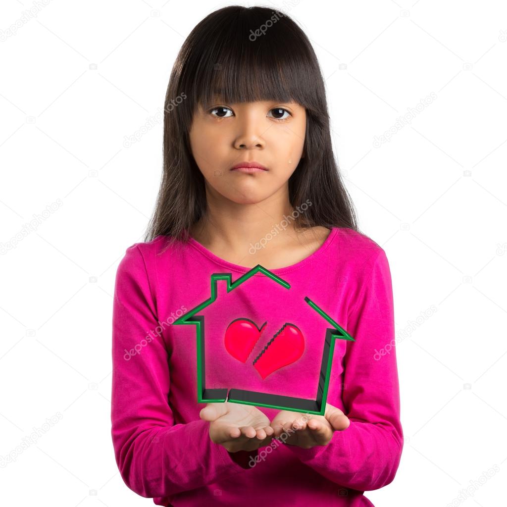 Sadness little asian girl holding virtual house with broken hear