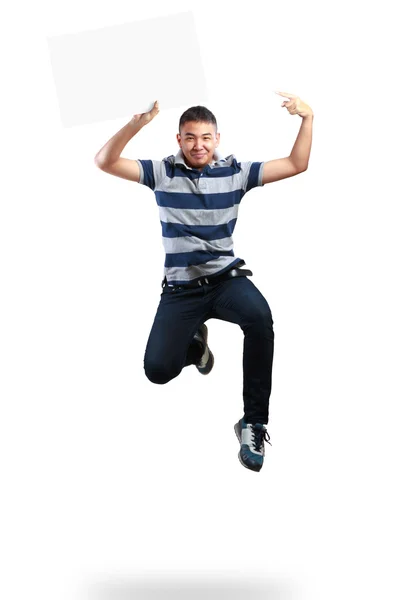 Adolescente chico saltando y sosteniendo en blanco papel —  Fotos de Stock