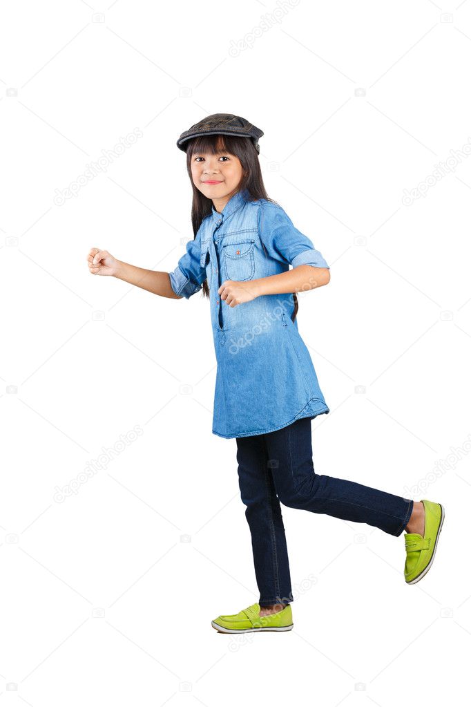 Smiling asian little girl in the action of walking
