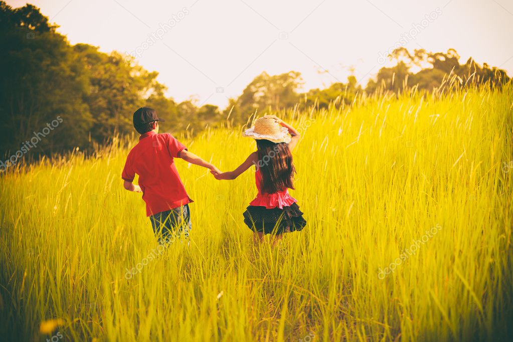 Happy children running at meadow