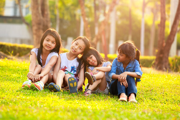 Four happy smiling child playing in park